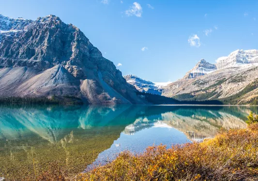 Open lake with reflections of the surrounding mountains and hills