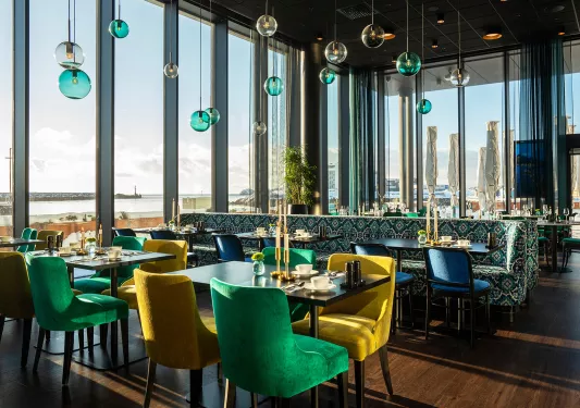 Dining area with large windows and circular light fixtures