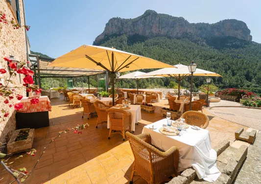 Outdoor dining patio with a view of a large mountain