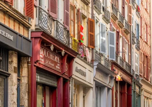 Alleyway of stores with apartment buildings on top