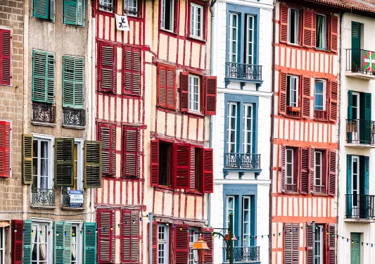 Tall row of apartments with colorful windows