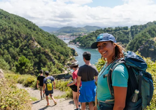 Group of people hiking with a woman turning around and smiling