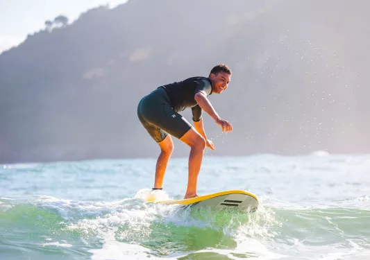 Man standing on a surfboard in the ocean
