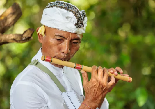Man playing a wooden flute