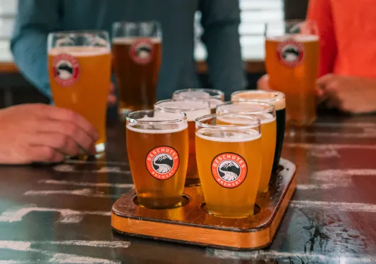Beer flight on top of a wooden plank