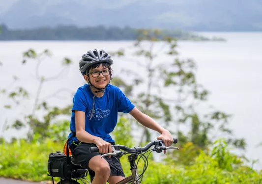 Teen boy smiling while riding a bike