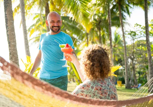 Man and woman holding colorful drinks and smiling