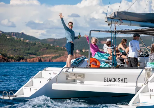 Group of people on a white boat smiling and laughing