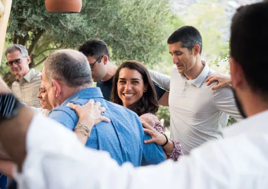 Group of people hugging and dancing