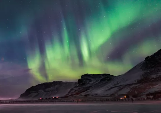 Snowy mountains with an aurora in the sky