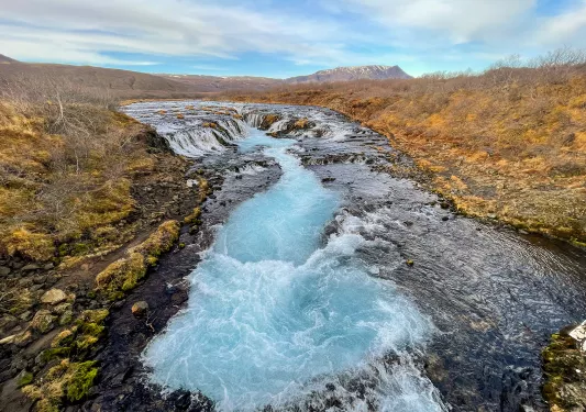 Small glacier in the middle of a dried field of crops