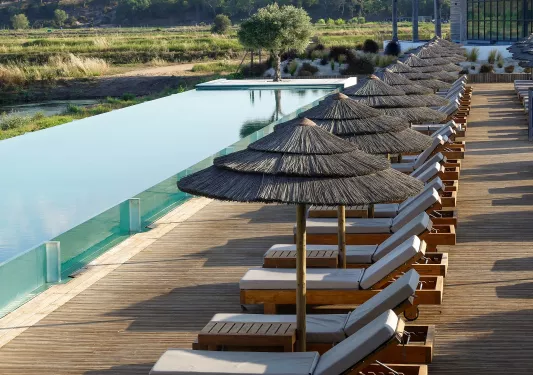 Reclining chairs in front of an infinity pool