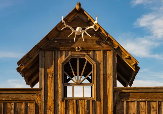 Wooden building with dried antlers hanging from the front