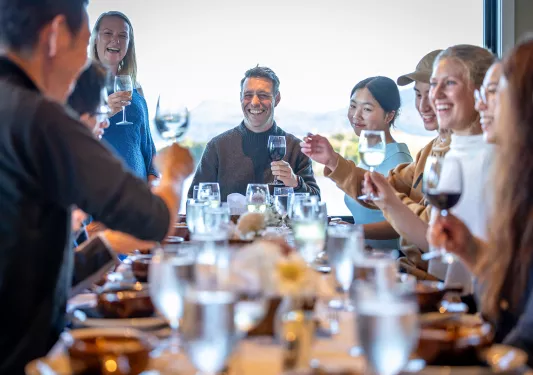 Backroads guests gather celebrate around a dinner table