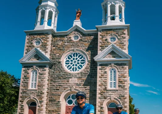 Backroads guests cycle in front of a church