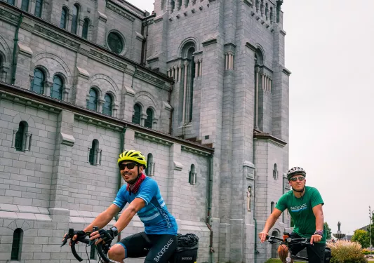 Backroads guests cycle past a large stone castle