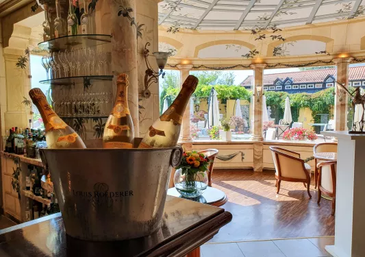 Bar and lounge with an ice bucket filled with three bottles of wine