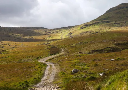 Gravel trail in the middle of a dried valley