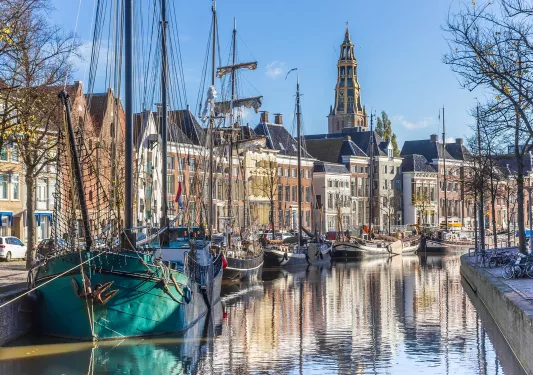 Town with a long river with boats floating along the river