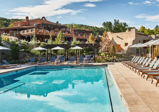 Outdoor pool surrounded by gray, reclining chairs