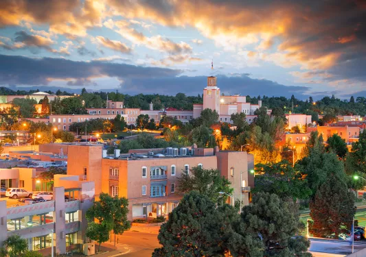 Town with building illuminated by orange lights