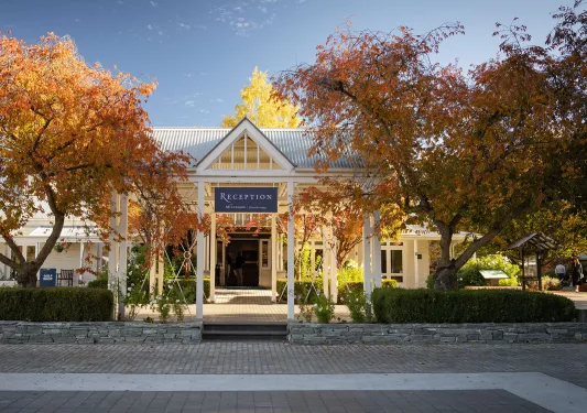 Exterior view of hotel reception building with a stone pathway