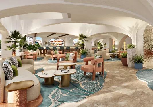 Bar and lounge with a bar counter in the back and cushioned chairs throughout the large room