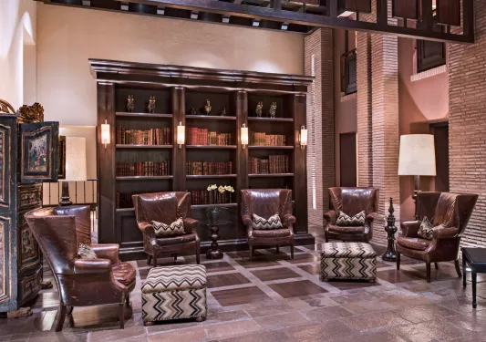 Library and seating area with 4 large leather chairs
