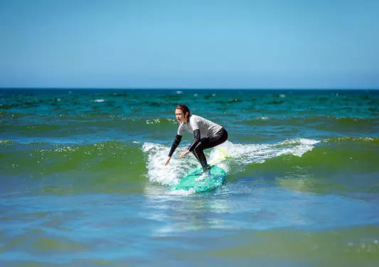 Woman riding a surfboard in the ocean