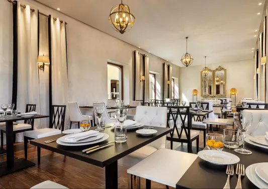Restaurant with square black tables with white plates
