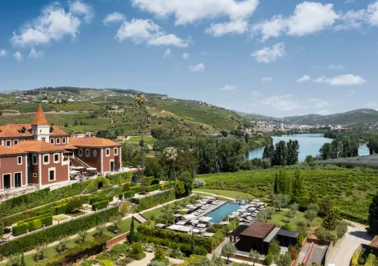 Top view of red building with a garden and outdoor pool in front