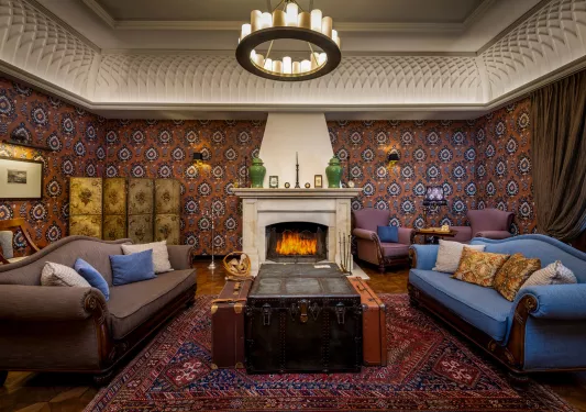 Seating area with a fireplace and two large, cushioned sofas