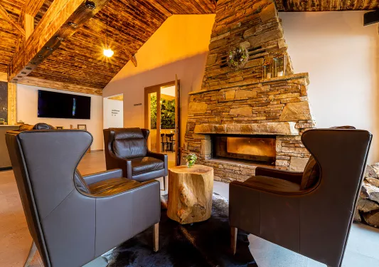 Hotel lobby with leather chairs in front of a stone fireplace