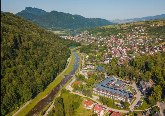 Sky view of small town with a thick forest to the left