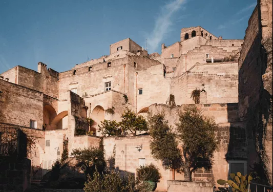 Stone building complex with small trees surrounding