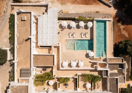 Top view of an outdoor pool and stone building complex