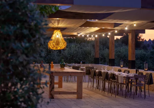 Outdoor patio with dining tables and a large light fixture