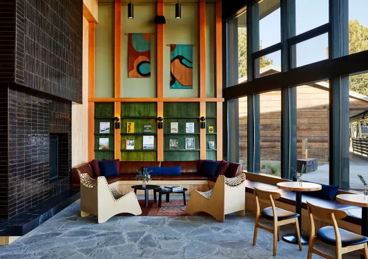 Corner room with library along the walls and large windows to the right