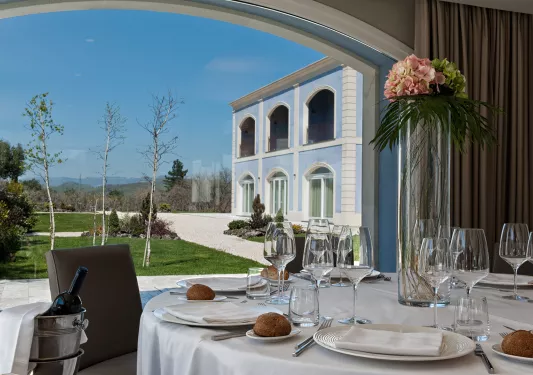 A table is set on a patio at Villa Neri