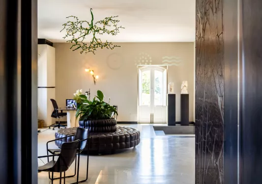 Hotel lobby with marble flooring and a leather couch in the center