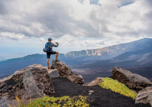 A Backroads guest enjoys the view at the summit of a hike