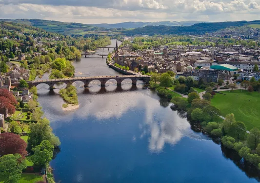 River cutting between a town with a bridge in the center