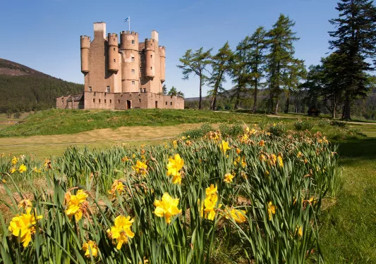 Brown, castle-like building with a big valley in front