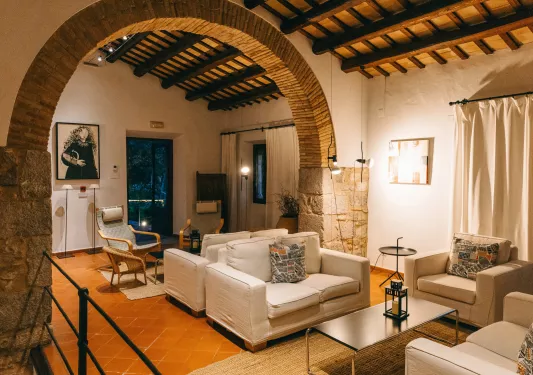 Seating and lounge area with beige couches and stone walls