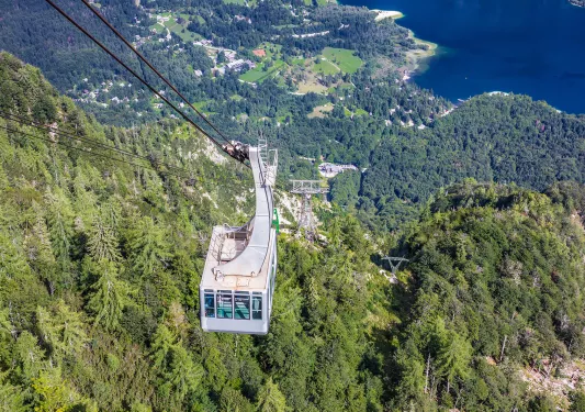 Sky lift with views of a forest and the ocean in the background