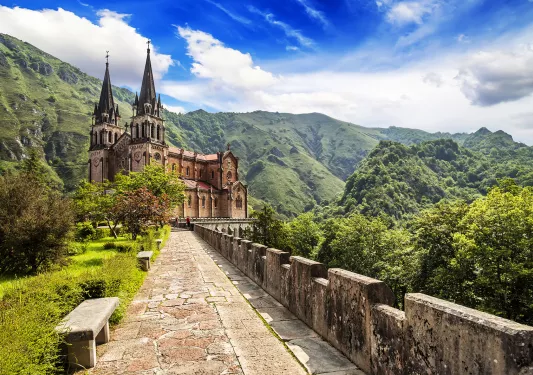 Long brick path leading to a castle-like church building