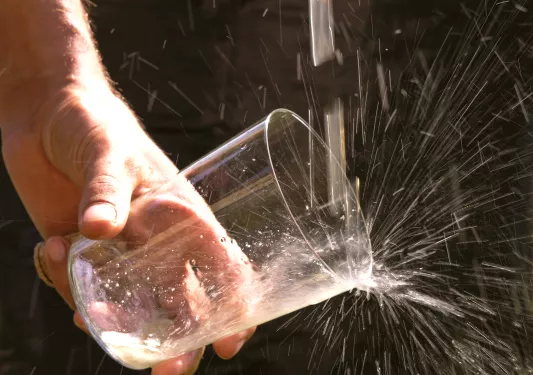 Hand washing a cup under a stream of water