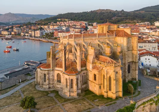 Rustic, castle like building with a lake in the background