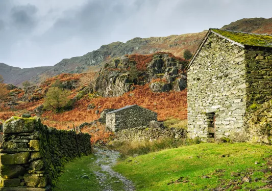 Stone buildings in the middle of a rocky and grassy hill