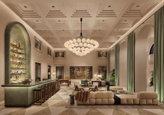 Hotel lobby with large chandelier and couches around the room